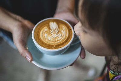 Close-up of hand holding coffee cup