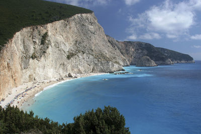 Scenic view of sea and mountains against sky