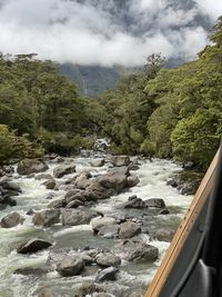 Scenic view of river amidst mountains against sky