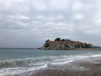 Scenic view of sea and buildings against sky