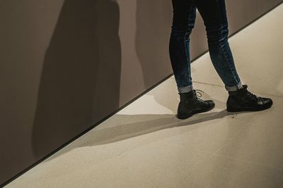 Low section of woman standing on tiled floor