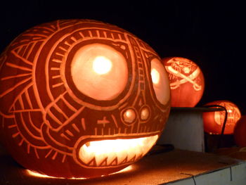 Close-up of illuminated lamp on table