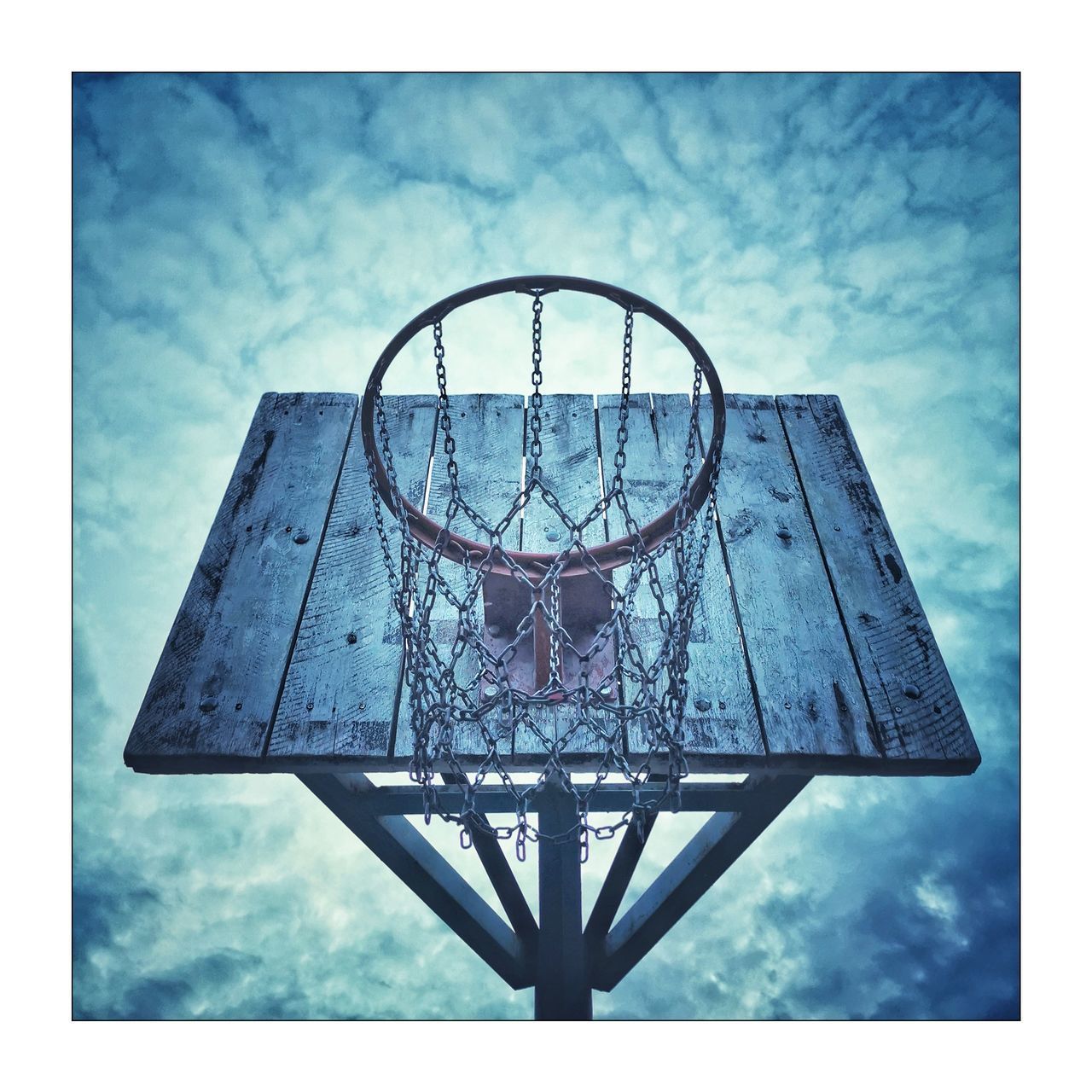 LOW ANGLE VIEW OF BASKETBALL COURT AGAINST SKY