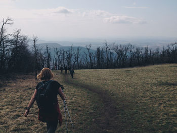 Scenic view of grassy field against cloudy sky