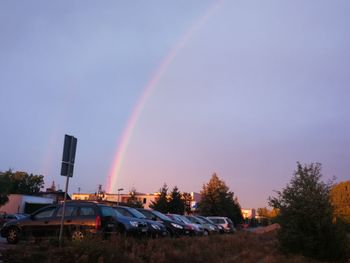 Low angle view of rainbow over city against sky