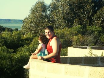 Portrait of young man sitting on bench