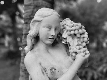 Close-up of angel statue in cemetery