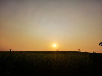 Scenic view of field against sky during sunset