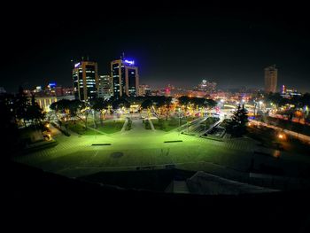 Aerial view of city lit up at night