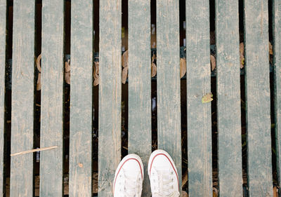 Low section of woman standing on footpath