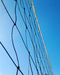 Low angle view of net against blue sky