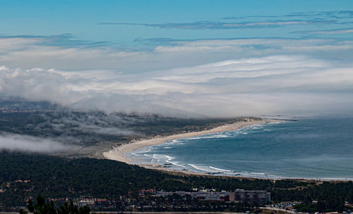 High angle view of sea and cityscape against sky