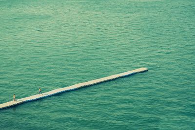 Long jetty at calm blue sea