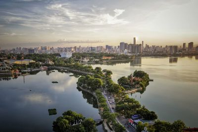 High angle view of river and buildings against sky