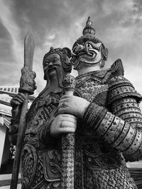 Low angle view of statue against temple building