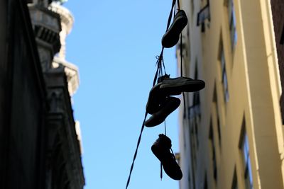 Low angle view of clothes hanging against clear sky