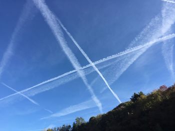 Low angle view of vapor trail against blue sky