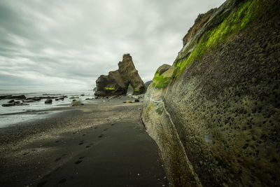 View of beach against cloudy sky