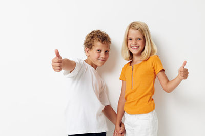 Portrait of sibling gesturing in studio