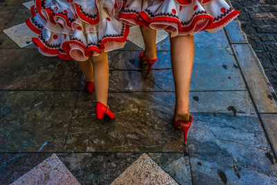 Low section of women walking on zebra crossing