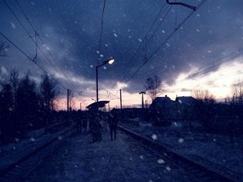 Wet road against sky at night