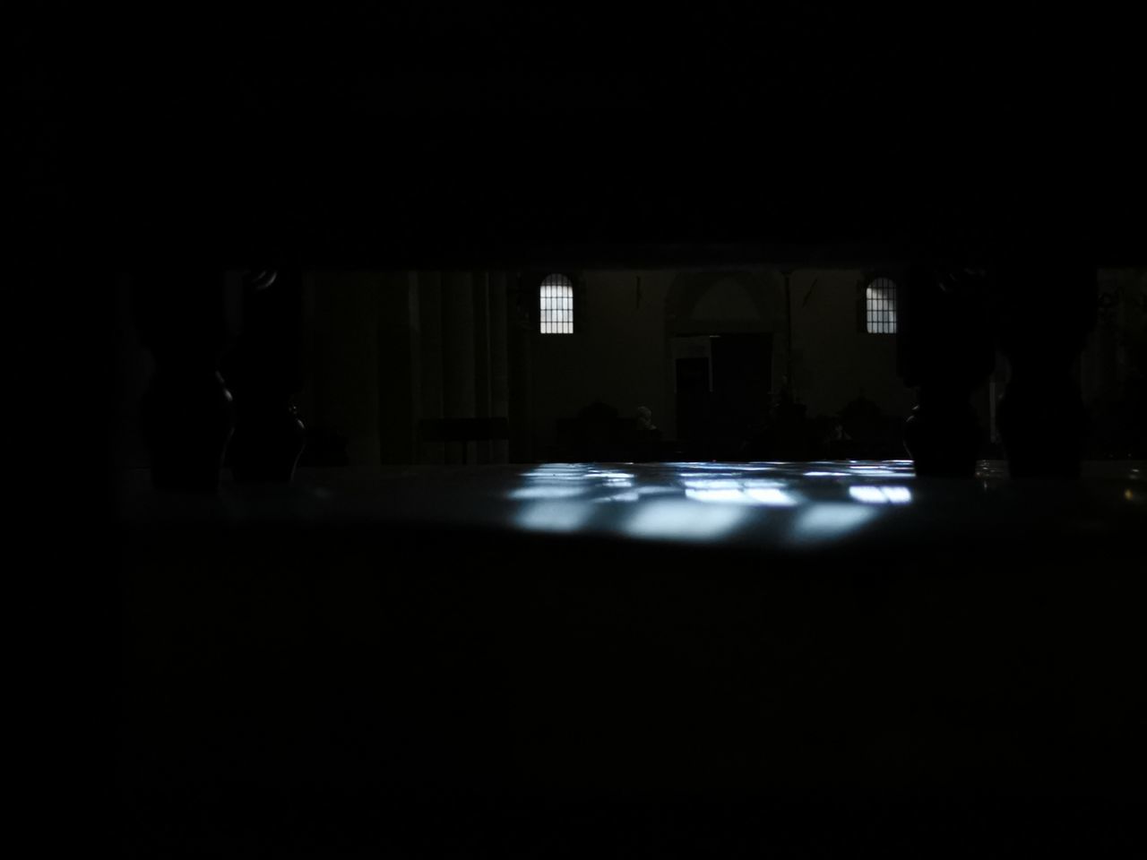 PEOPLE IN ILLUMINATED BUILDING AT NIGHT