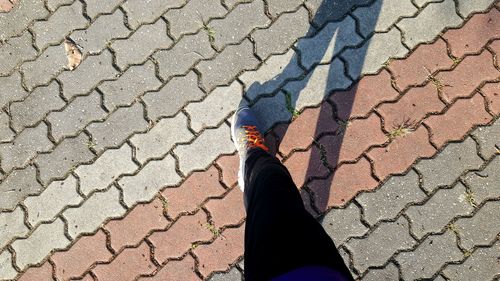 Low section of person walking on footpath