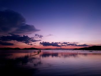 Scenic view of lake against romantic sky at sunset