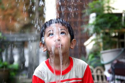 Portrait of wet boy in rain