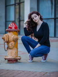 Portrait of young woman sitting outdoors