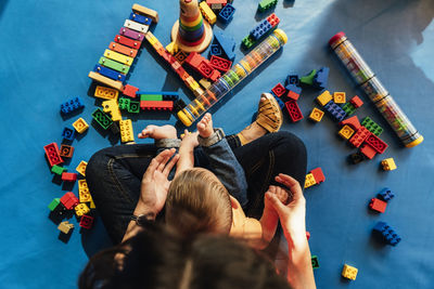 High angle view of people playing with toy at home