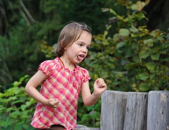 Smiling girl standing outdoors
