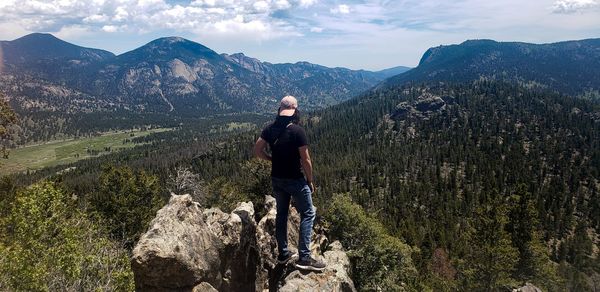 Full length of man looking at mountains against sky