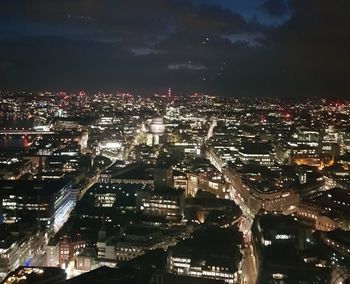 High angle view of illuminated cityscape against sky at night