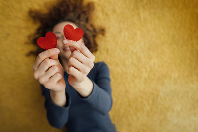 Close-up of two hearts in the hands that young woman gives, defocused