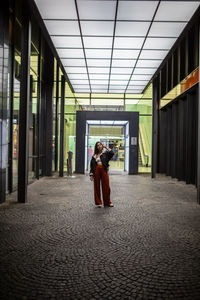 Woman standing in corridor
