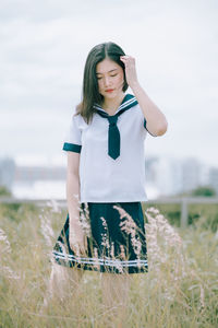 Young woman standing on field
