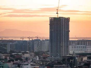 Cityscape against sky during sunset