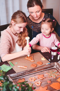 Family preparing gingerbread cookies at home