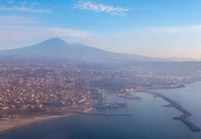 High angle view of sea and cityscape against sky