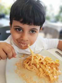 Close-up portrait of boy holding food