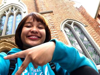 Portrait of smiling boy sitting outdoors
