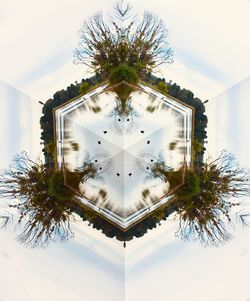 Low angle view of palm tree by building against sky