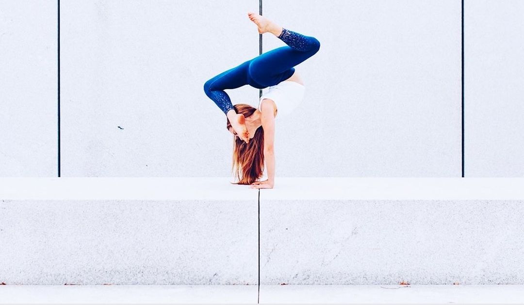 one person, wall - building feature, full length, real people, young women, women, built structure, young adult, balance, architecture, lifestyles, dancing, leisure activity, indoors, copy space, side view, clothing, standing, day, human arm, arms raised