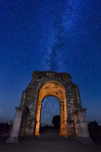 Low angle view of old ruin against sky at night