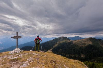 Man standing on mountain against sky