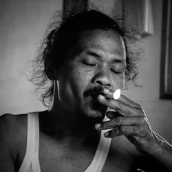 Portrait of young man smoking cigarette