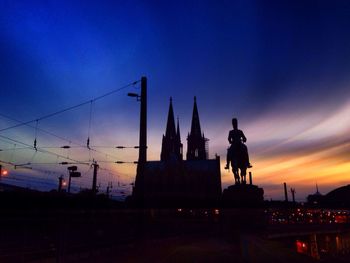 Silhouette of statue against sky during sunset