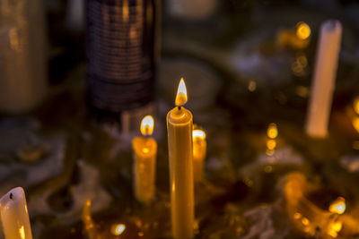 Close-up of lit candles in temple