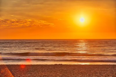 Scenic view of sea against orange sky